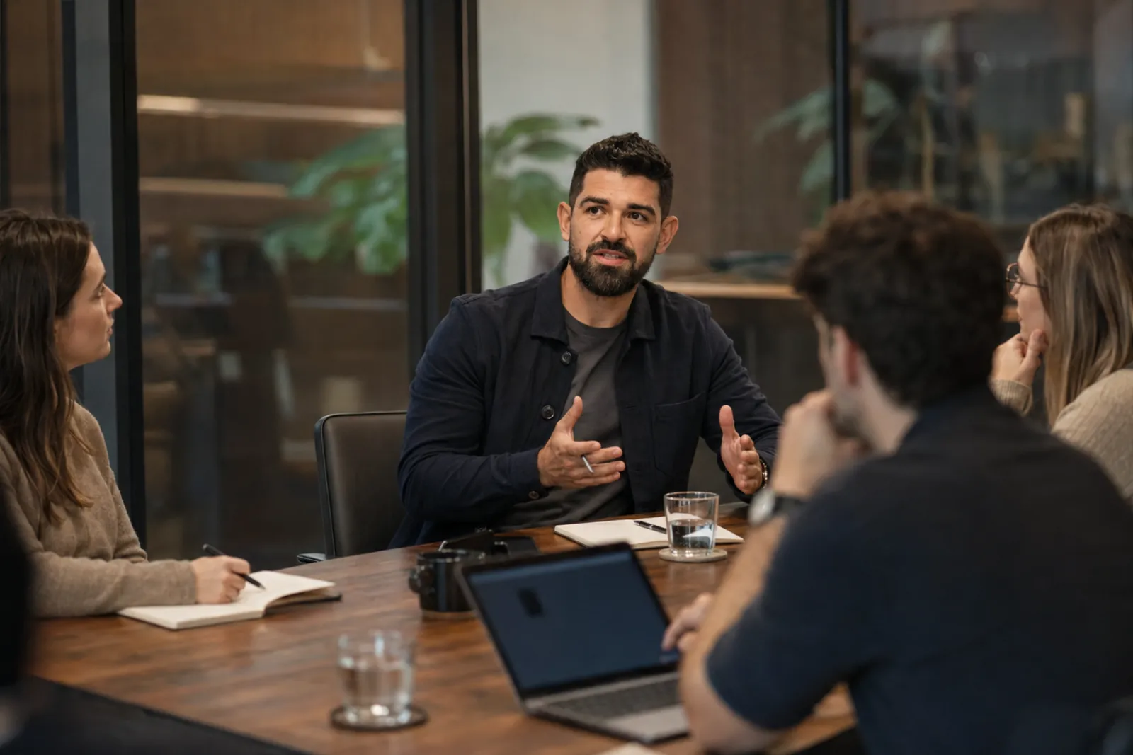 Yan leading a working session with a client team around a table
